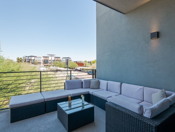 1st Floor: Private balcony off the living room offering outdoor furnishings for lounging.