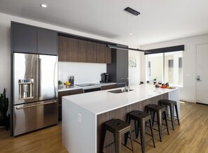 1st Floor: Fully equipped modern kitchen completely stocked with all culinary essentials and includes high-end Cafe stainless steel appliances.