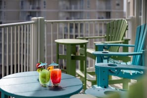Kick back with a cold drink and ocean breeze on your colorful private balcony lounge
