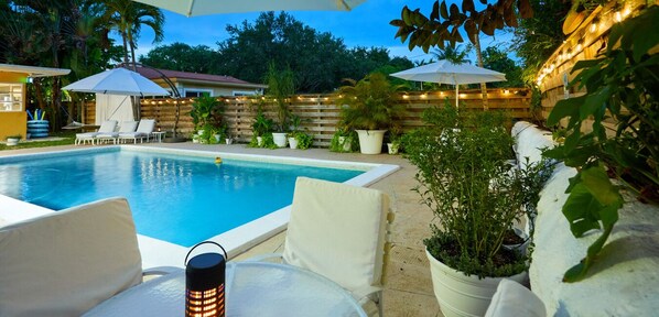 Your evening oasis—string lights, warm water, and Miami nights that feel like magic.
