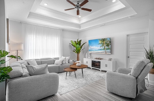 In the living room plentyof space for everyone to rest confortably on a large .