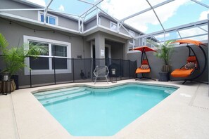 Gorgeous dip pool with hammock loungers and dining area, pool fence