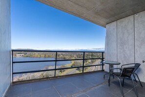 Balcony with table and chairs where you can sit, have your coffee, have some sunlight, and have some fresh air while appreciating the breathtaking view outside.