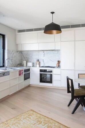  The sleek stone kitchen makes it easy to prepare meals at home, but you’ll also find plenty of eateries close by.
