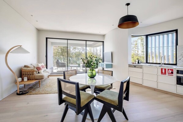 A four-seater glass top table offers ample space for the whole group to come together at dinner time.