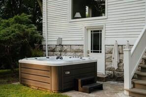 Unwind in the outdoor hot tub, the perfect spot to relax after a day of exploring.