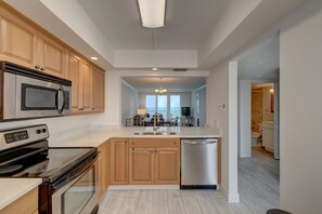 Kitchen looking out to oceanfront balcony