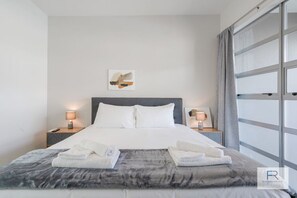 Master bedroom with TV and double wardrobe