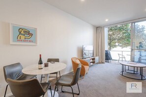 Open plan living area and dining table with 4 seaters
