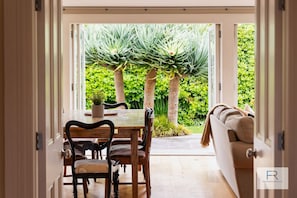 Open plan living with outdoor flow onto sunny deck and outdoor dining