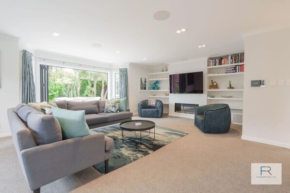 Beautifully appointed open plan lounge with gas fireplace