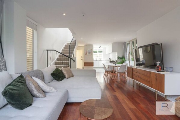 Living room with large luxurious couch and widescreen TV