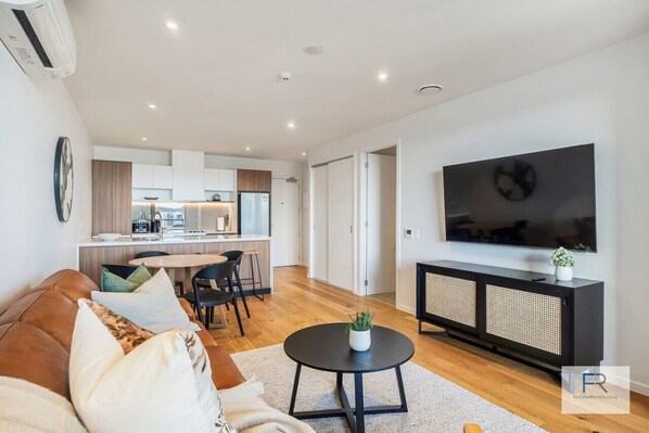 Stylish open plan living, kitchen and dining. Laundry behind sliding doors