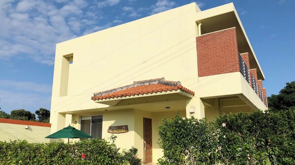 ・The exterior features white walls that stand out against the blue sky