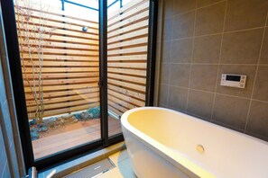 A deep and spacious bathtub.