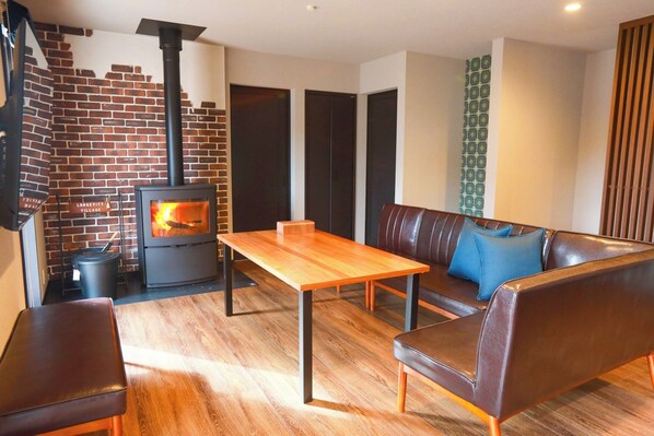 The living room with its warm fireplace is a cozy space for the whole family to relax.