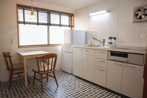 Kitchen. A typical kitchen equipped with a refrigerator and microwave.