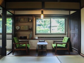 The sofa in the living room on the first floor. A "Enkuzu" plant is displayed on the windowsill next to it.