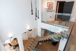 Ground floor entrance with a staircase leading down to the open-plan living area.