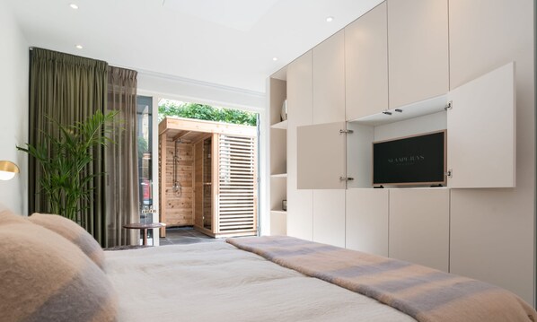 Bright and elegant bedroom with direct garden access — enjoy waking up to natural light and fresh air each morning.