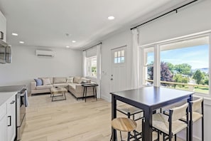 Step into this bright and modern kitchen, fully equipped with stainless steel appliances and ample counter space. The sleek design and thoughtful touches make it a joy to prepare meals and entertain guests. Enjoy casual dining at the stylish bar tabl
