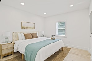 Retreat to this tranquil bedroom featuring a king-sized bed and soothing décor. The soft linens and calming color palette ensure a peaceful night's sleep. Enjoy the serene views and thoughtful touches that make this room a perfect haven for relaxatio