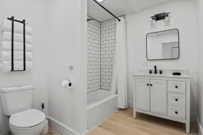 Refresh and rejuvenate in this modern bathroom, complete with a chic subway tile shower and sleek fixtures. The clean, white design and ample space create a serene environment for your daily routine. Indulge in a spa-like experience in this beautiful