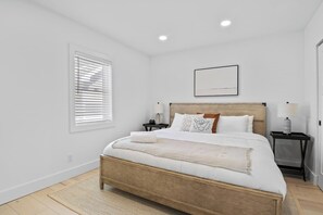 Retreat to this tranquil bedroom featuring a king-sized bed and soothing décor. The soft linens and calming color palette ensure a peaceful night's sleep. Enjoy the serene views and thoughtful touches that make this room a perfect haven for relaxatio