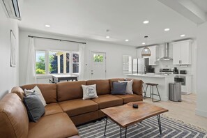 Enjoy ultimate relaxation in this contemporary living room, designed with your comfort in mind. The mounted TV and electric fireplace create a cozy atmosphere for movie nights or quiet evenings. Large windows and modern décor make this the perfect sp