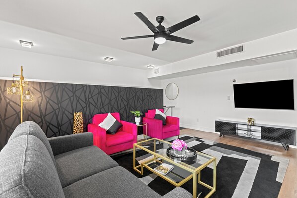 Welcome to the heart of our stylish retreat! Our living room exudes comfort and modern charm, featuring plush furnishings and contemporary decor.