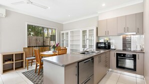 Discover efficiency and charm in our small but organized kitchen, where every inch is thoughtfully utilized for maximum functionality. With clever storage solutions and tidy countertops, this inviting space makes cooking a breeze while maintaining a cozy 