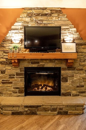 "Cozy up by the charming stone fireplace."