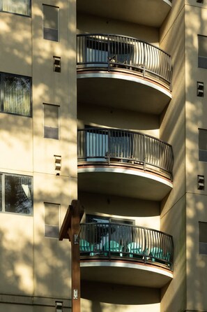 "Enjoy serene mornings on the balcony with comfortable seating."