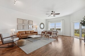 Bright and Airy Living Space Featuring a Flat Screen Smart TV with Cable and Balcony Access