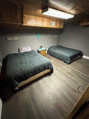 Fourth bedroom downstairs with two queens