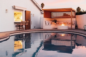 Gather up around the custom fire pit area or take a dip under the moody twilight reflection.