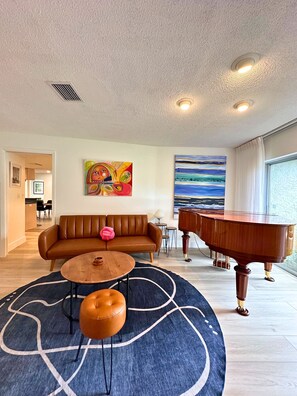 Our second living room has a sofa bed,and futon. It also features a grand piano.