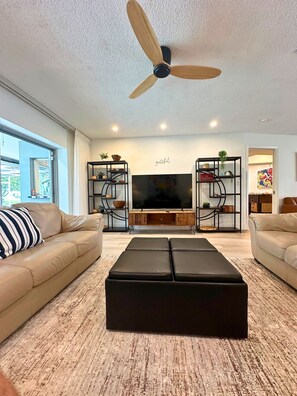 Open concept living,kitchen and dining with ample seating,foosball and golf view