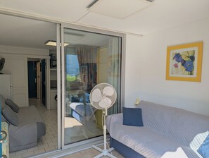 Closed loggia with sofa open to the living room