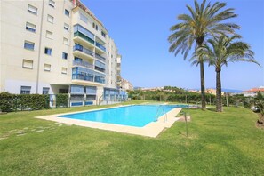 Inviting communal swimming pool surrounded by gardens