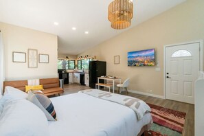 Relax in comfort with a queen-sized bed, perfectly positioned for cozy movie nights on the smart TV!