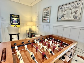 A Game Room with Arcade Pacman, Foosball, Soft Tip Dart Board, puzzles, games, etc.
