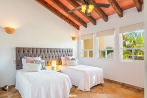 Guest bedroom with 2 twin beds and adjacent full bathroom