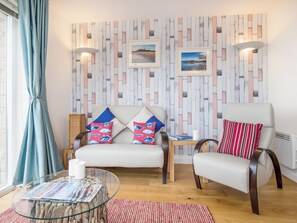 The living room boasts leather sofa and chair | Spindrift, Seahouses