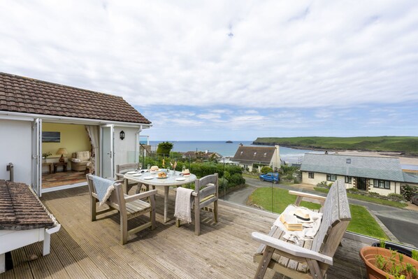 Stradav, Polzeath. Second Floor: Front-facing balcony with panoramic sea views and outdoor furniture