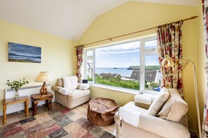 Stradav, Polzeath. Second Floor: Relax on the armchairs whilst taking in the sea views