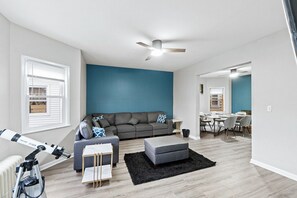 Spacious living area featuring a comfortable sectional sofa and a chic design, perfect for relaxing.