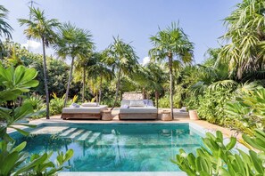 Pool Area | Cenote pool front view with loungers.
