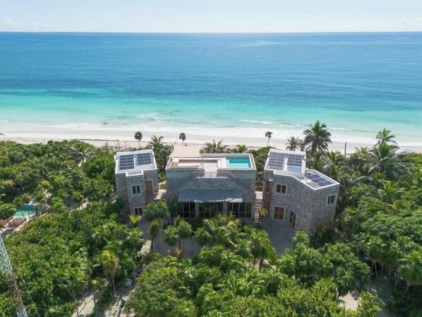 Drone view of grounds with 3 areas and rooftop pool.