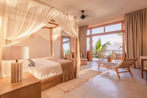 Master Bedroom 1 | Beds with ocean views and balcony.